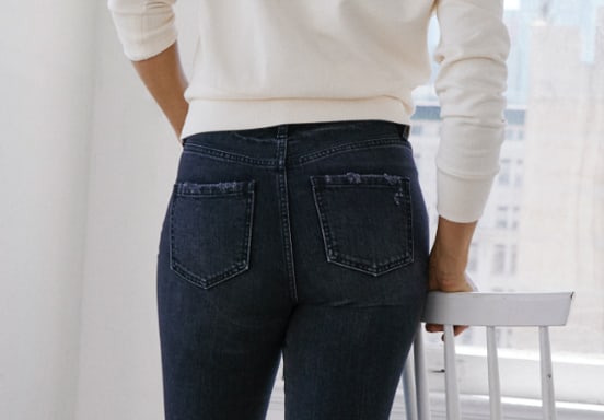 Black skinny jeans featuring flattering fit technology, a high rise and frayed leg opening