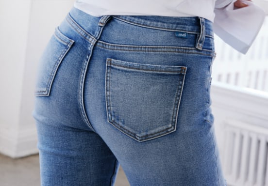 Skinny jeans featuring flattering fit technology, a mid rise and distressed light indigo wash
